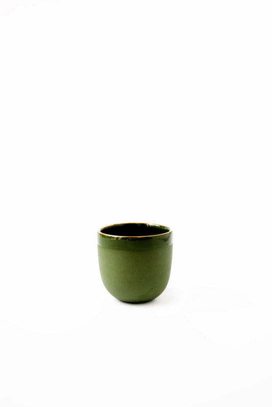 Small green ceramic espresso cup with a gold rim, sitting on a white background.