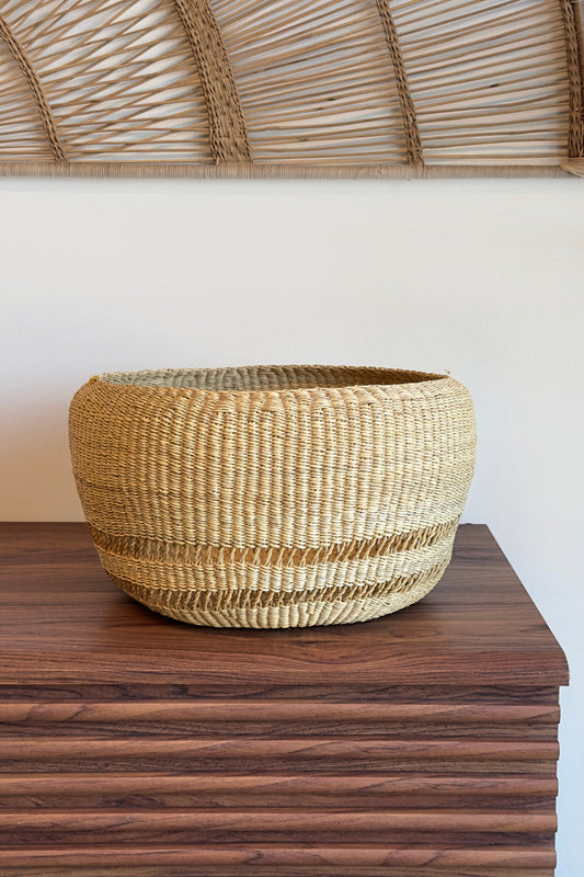 Round woven basket on wooden table
