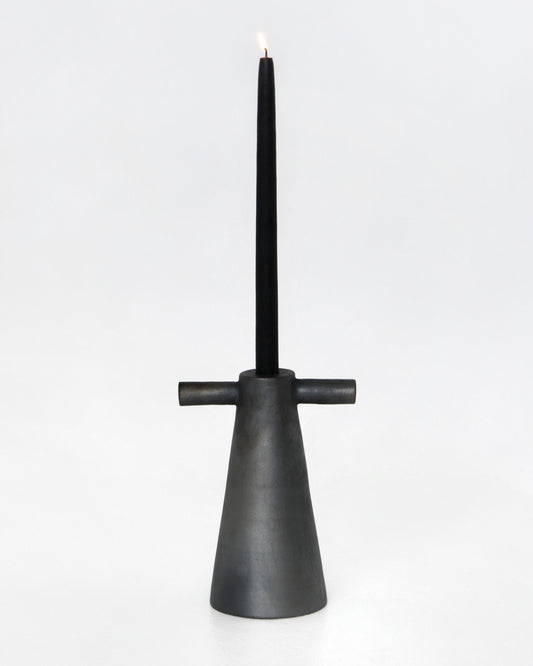 Black stoneware tall candle holder with simple design on plain background