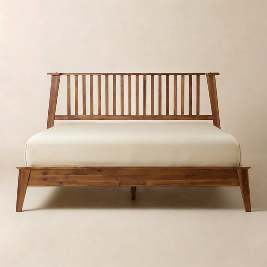 A wooden bed frame with vertical slats and a simple design, set against a plain background with a white mattress on it.