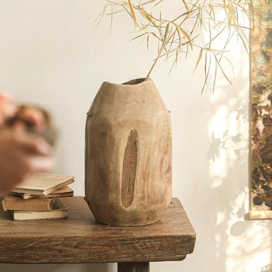 Homestead Solid Wood Décor Vase on a rustic wooden table, natural wood colour, bamboo branch in background, books to left, natural light from right.