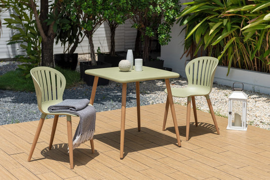 Nassau Square Table in Sage Green Social Plastic® with chairs and decor on wooden deck