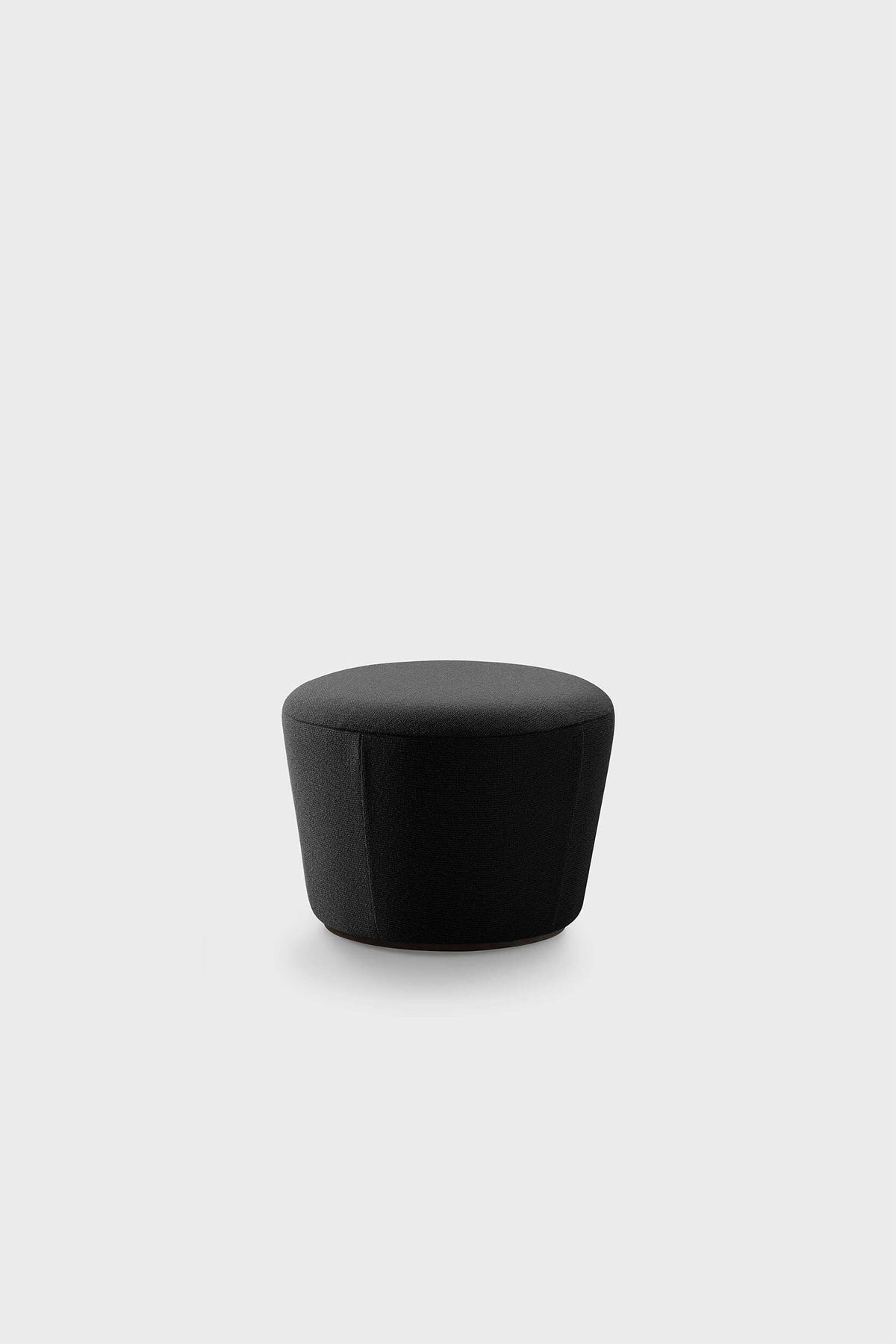 Black pouf with textured fabric on white background