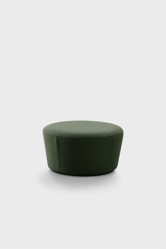 A small, round, dark green pouf against a neutral background