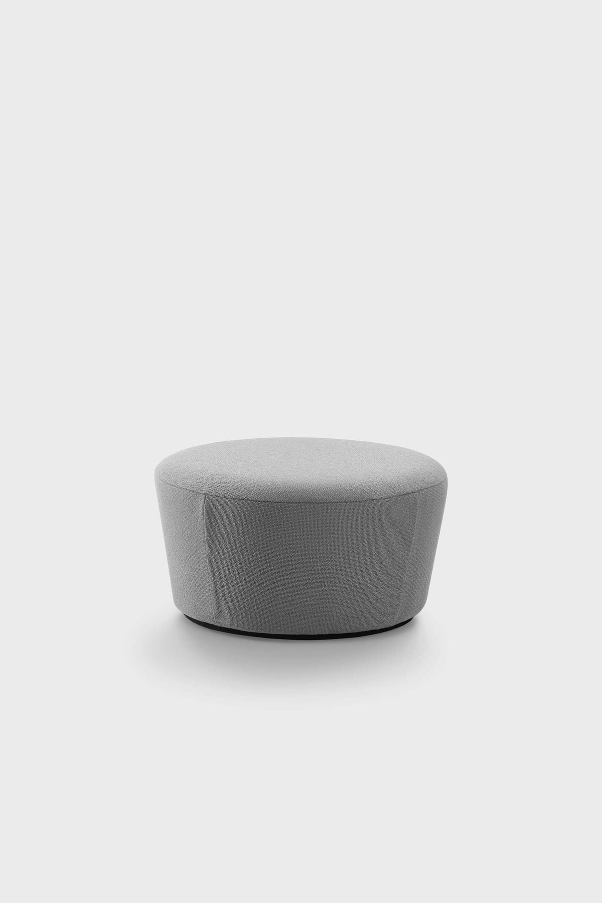 A light grey pouf with a textured upholstery sits on a plain background.