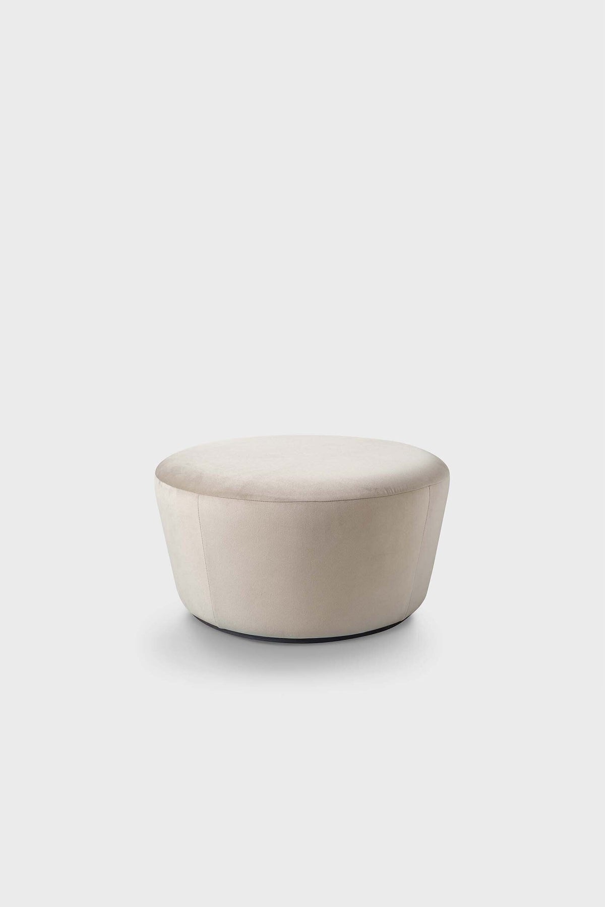 Beige pouf with soft finish on light background