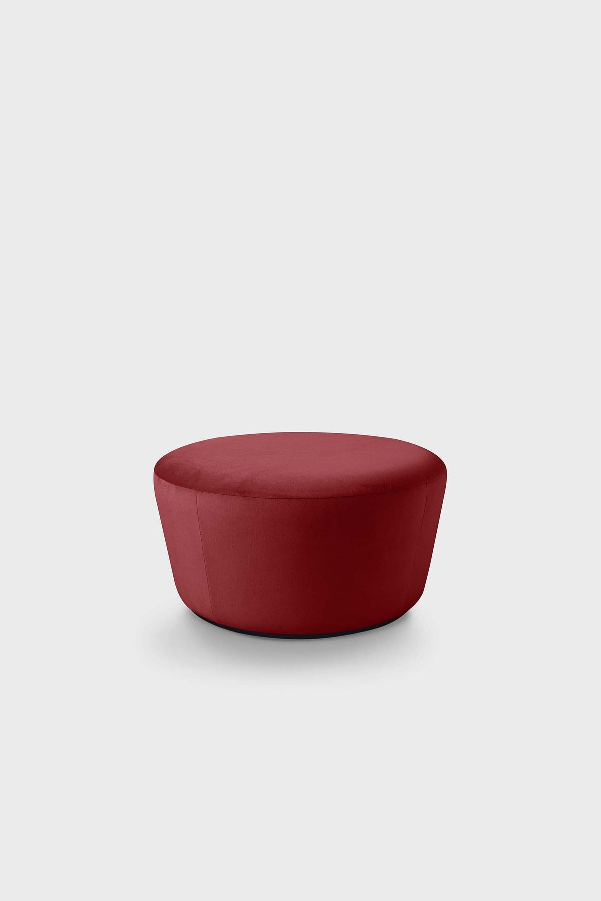 Circular red pouf on grey background
