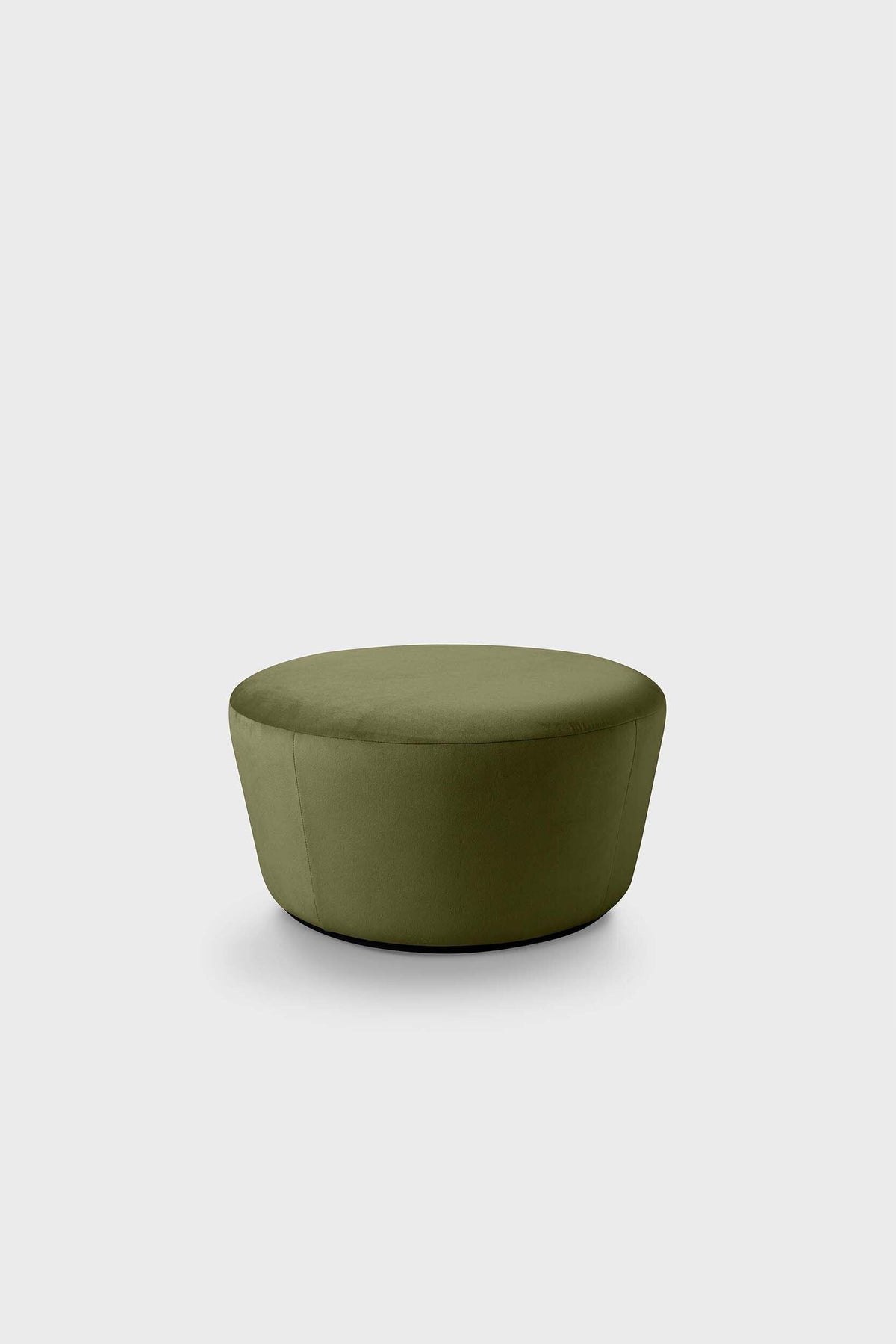 Simple round ottoman upholstered in dark green fabric with a matte finish.