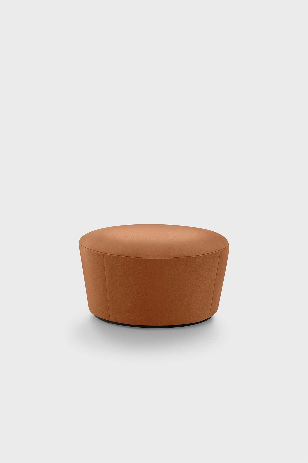 A round, brown upholstered pouf with a simple design on a plain background.