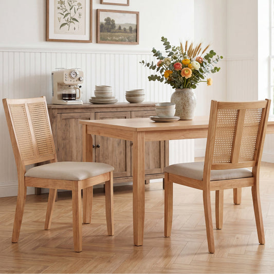 Wooden dining chair with woven backrest and cushion seat, beside minimalist table with flowers in vase.