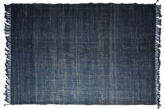 Dark blue jute rug with hand-finished edges and visible weave texture.