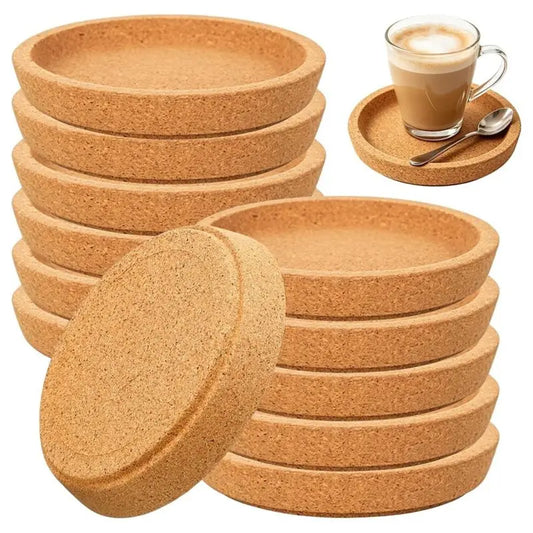 Stacks of round cork coasters with a coffee and saucer in the background