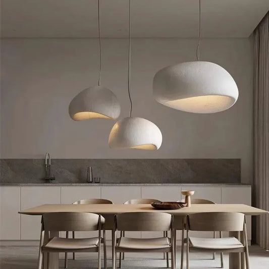 Modern LED ceiling chandelier lights with white textured lampshades in a dining room setting.