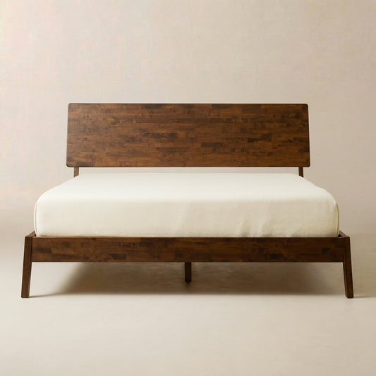 Serenity Solid Wood Bed Frame: dark brown wood with a white mattress, minimalist setting on light beige surface and walls.