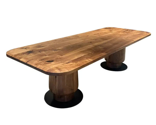 Solid walnut edge-glued dining table with two wooden tulip pedestal legs on black metal disc bases