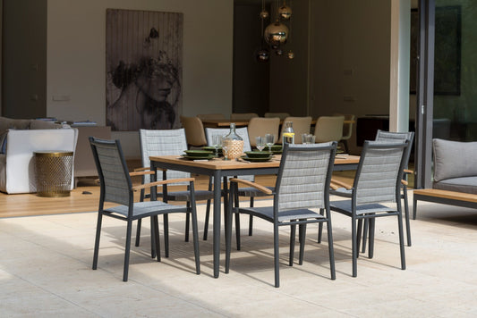 Topaz Rectangular Small Dining Table with metal frame and fabric seats, set in a modern dining area with contemporary decor.