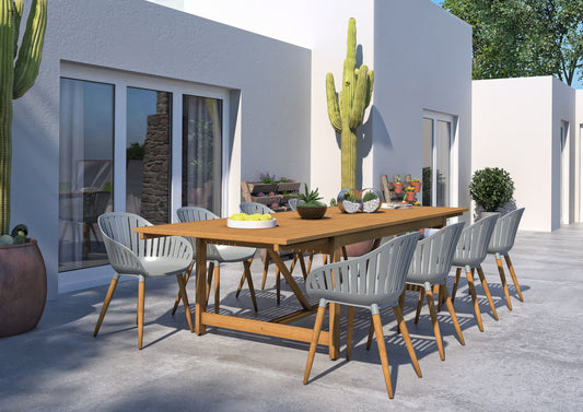 Outdoor dining set with wooden table and grey chairs, cacti in the background