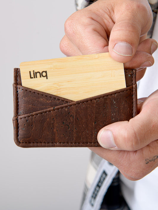 Cork and wood cardholder with engraved text in hand