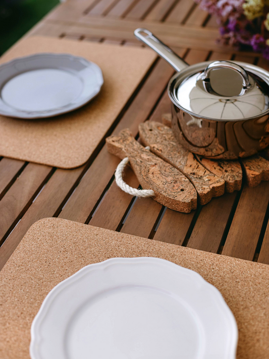 Azulejo Cork Placemats (Set of 4) on a wooden table with white plates, a saucepan, and a rope handle.
