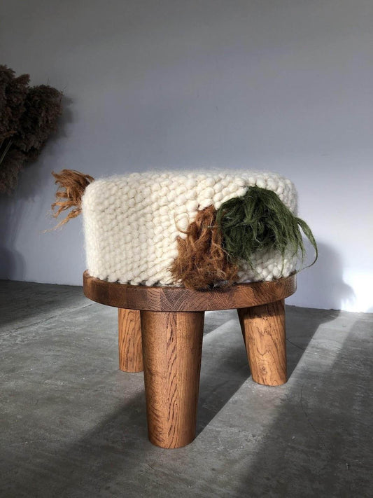 Hand-knitted pouf 'Forest' with natural fibers on wooden legs against a neutral background