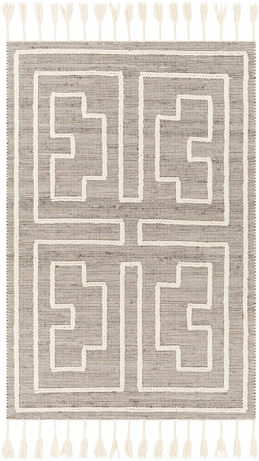 Knit rug with Greek key pattern in cream and gray tones, featuring tassels at corners, no visible setting.