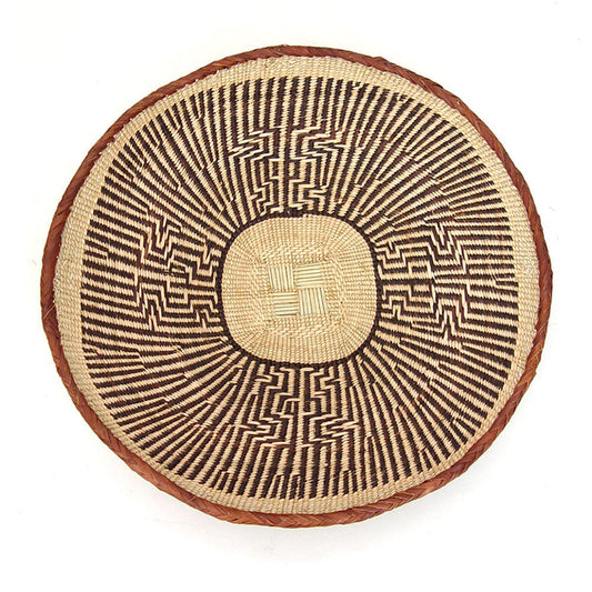 Circular woven Tonga Basket with tan, tan and dark brown geometric pattern, on plain white background.