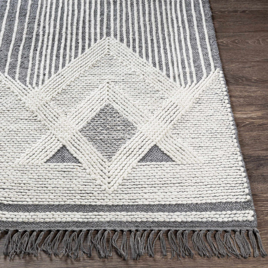Aldbourne Gray Tassel Flatweave Wool Rug, gray and white rug with diamond pattern and tassels, wooden floor background
