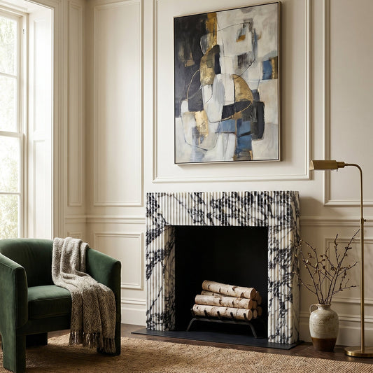Calacatta Viola Marble fluted fireplace mantel in a living room setting with abstract art above it and birch logs inside the firebox.