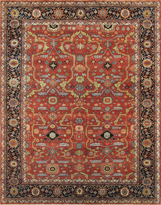 A handmade area rug with intricate floral and geometric patterns, featuring red, blue, and gold colors on a black border, displayed in a studio setting.