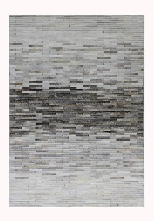 Patchwork rug with horizontal sections in varying shades of grey.