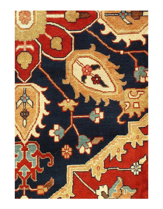 A detailed rug with a silkroad serapi design in red, blue, and beige hues on a navy base