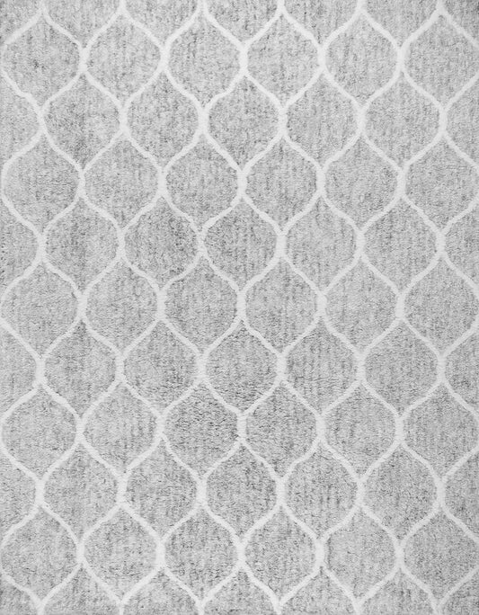 A close-up of a hand-woven rug with a geometric Moroccan pattern in muted tones, showing the pile texture.