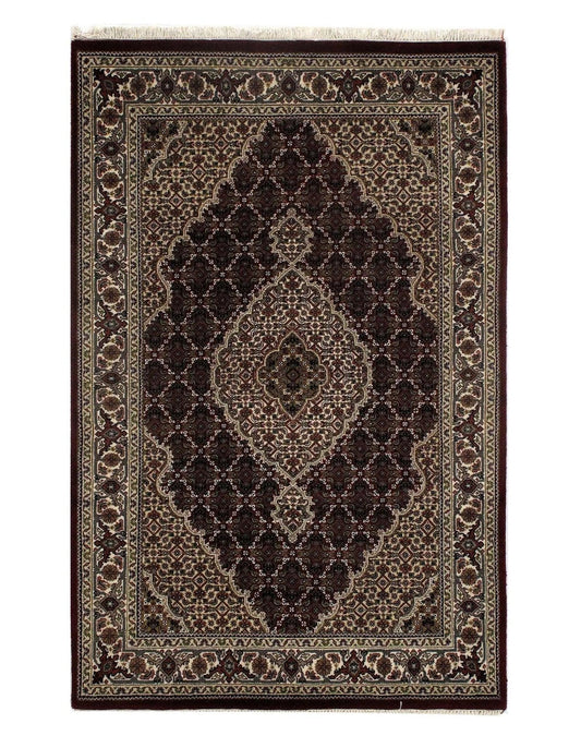 Dark brown and beige intricately patterned rug.