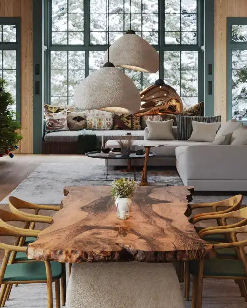 A living room with rustic furniture, a raw-edge wood table, and stone-textured pendant lights.