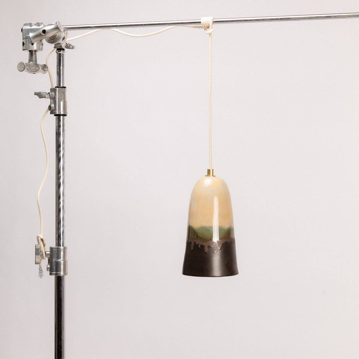 Ceramic Pendant Light Hand-Painted Horizon Glaze, hanging from a stand