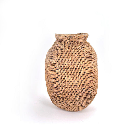 A large woven basket with a textured pattern, light brown in color, against a white background.