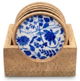 Blue-and-white floral coasters held in a wooden stand.