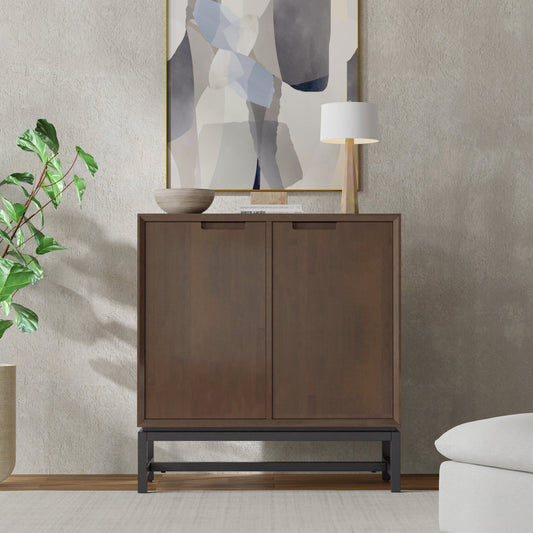 Mahogany-colored wooden cabinet with a metallic base in a minimalist interior with abstract art.