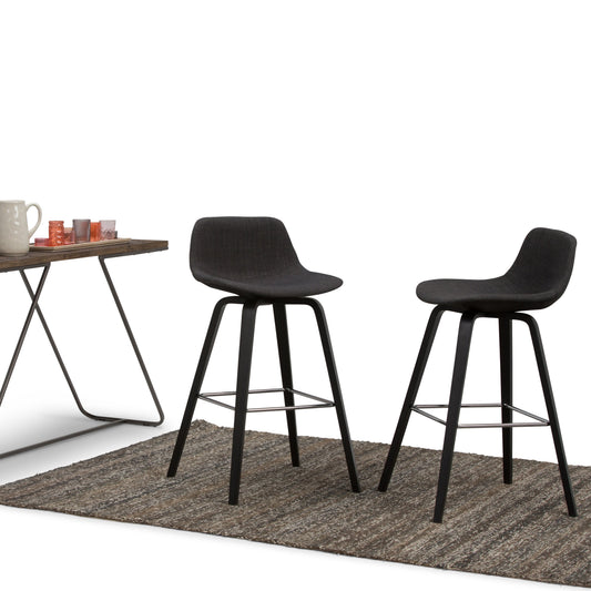 Two black Randolph Bentwood Counter/Bar Height stools on a mat, set against a light background with a table in the corner.