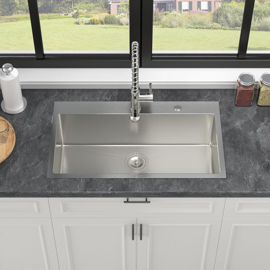 A 33 inch topmount stainless steel kitchen sink with a single faucet in a modern kitchen setting