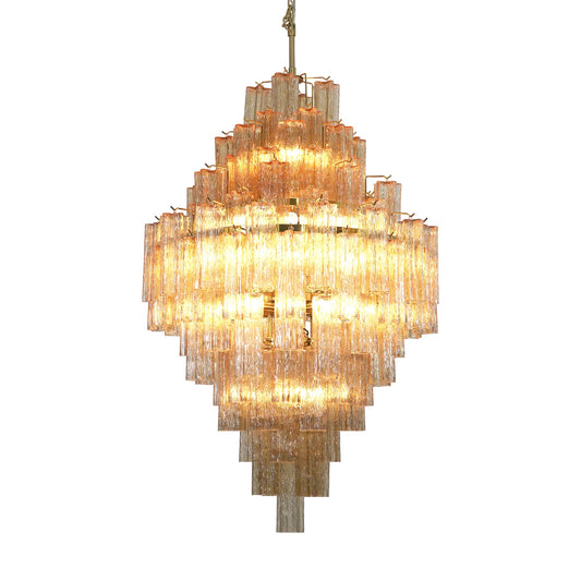 A star-shaped glass chandelier with brass accents hanging against a white background