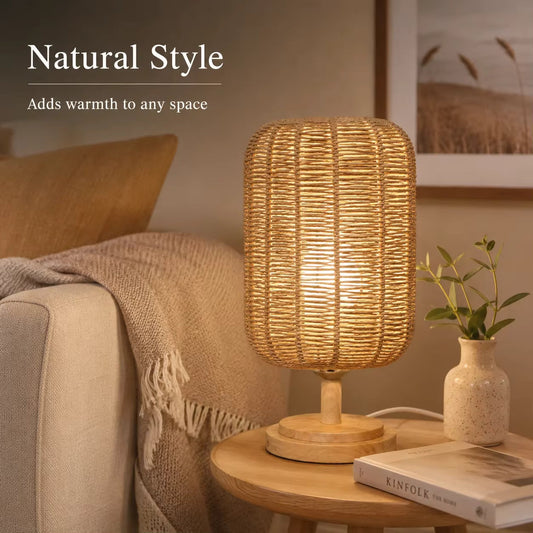 Handcrafted natural hemp rope table lamp with woven wooden base, warm beige lighting, beside a couch in a cozy living room setting.
