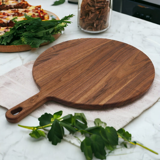 A rustic wooden cutting board with a handle, natural finish, dark brown, on a white marble surface with herbs.