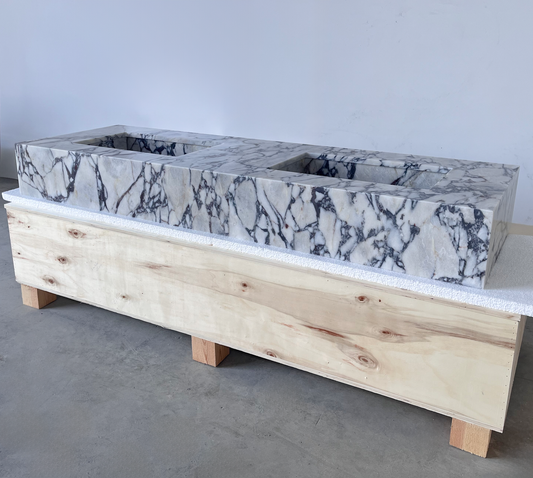 Double rectangular sink with calacatta marble top and natural wood base