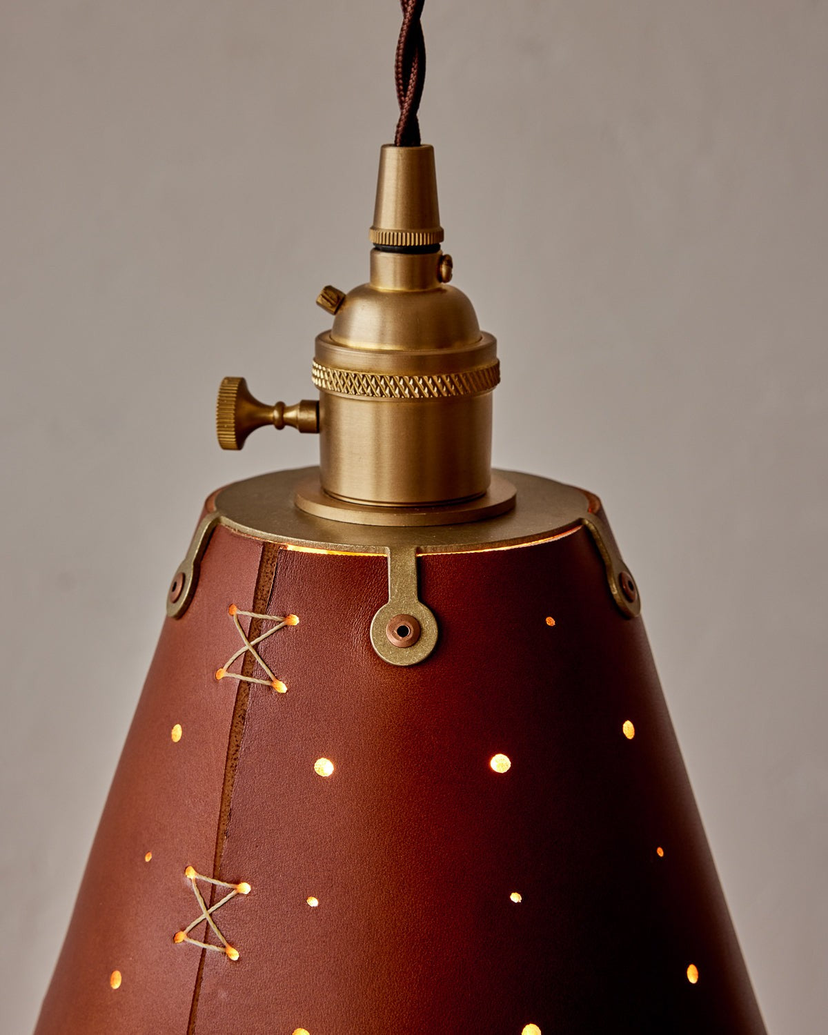 Leather Cone Pendant Light Perforated Shade, Tan leather, brass fitter close up