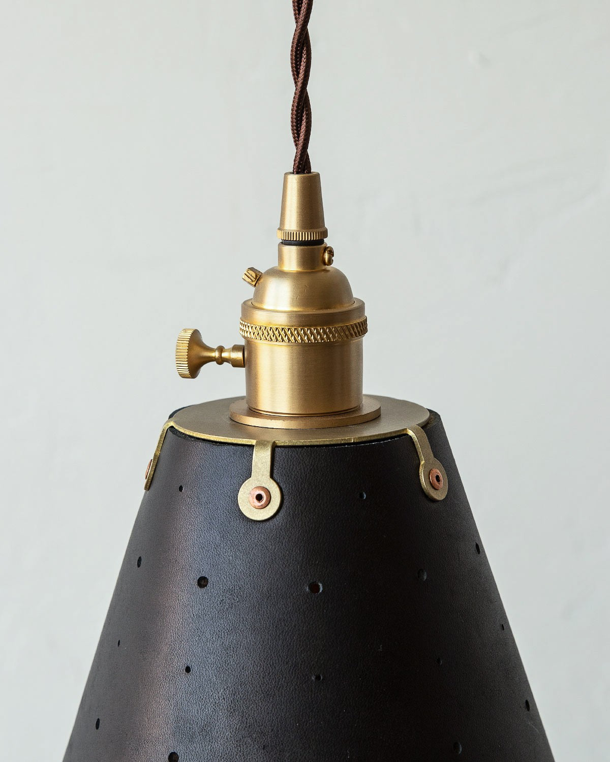 Leather Cone Pendant Light Perforated Shade, Black leather, brass fitter close up