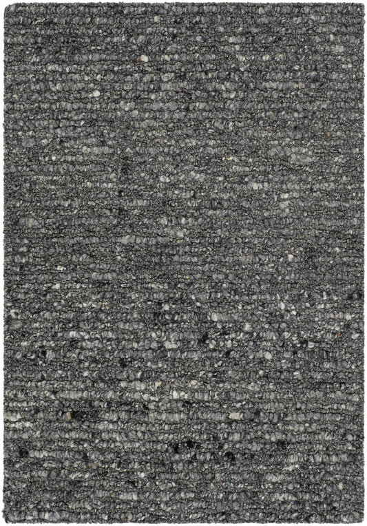 Dark gray, textured wool rug with a hand-woven construction, shown close-up.
