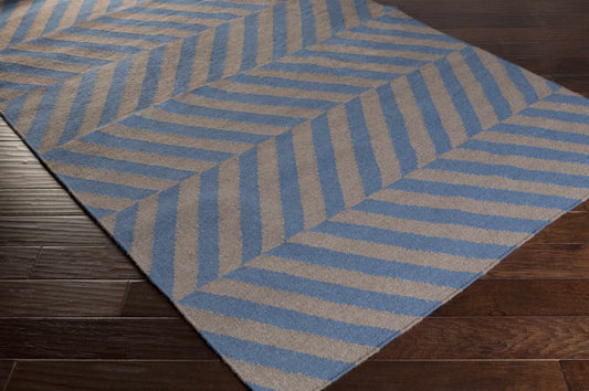 Blue and gray geometric patterned rug on wooden floor