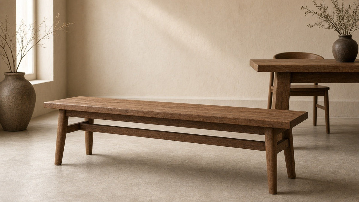 Sparrow solid wood dining bench brown in empty dining room, warm plaster walls, soft daylight