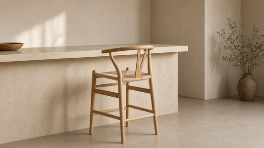 Wishbone island counter stool in empty kitchen, warm plaster walls, soft daylight